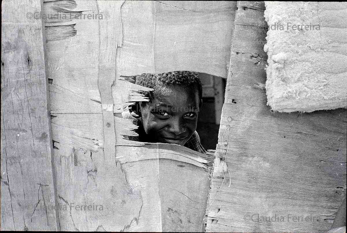 Boy Looking Through A Hole In A Wall